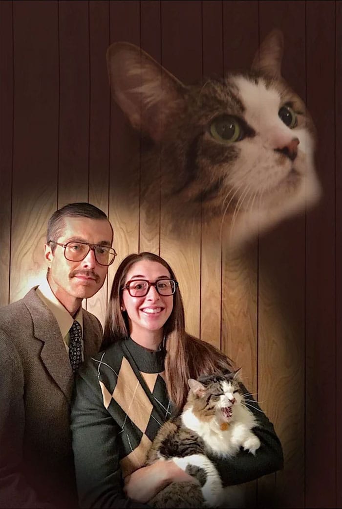 Funny Christmas card featuring a couple with glasses holding a yawning cat, with a large cat face above them.