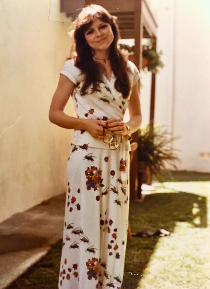 Smiling woman in floral dress standing outdoors, 1973, world-in-pictures theme. Smiling woman in floral dress standing outdoors, 1973, world-in-pictures theme.